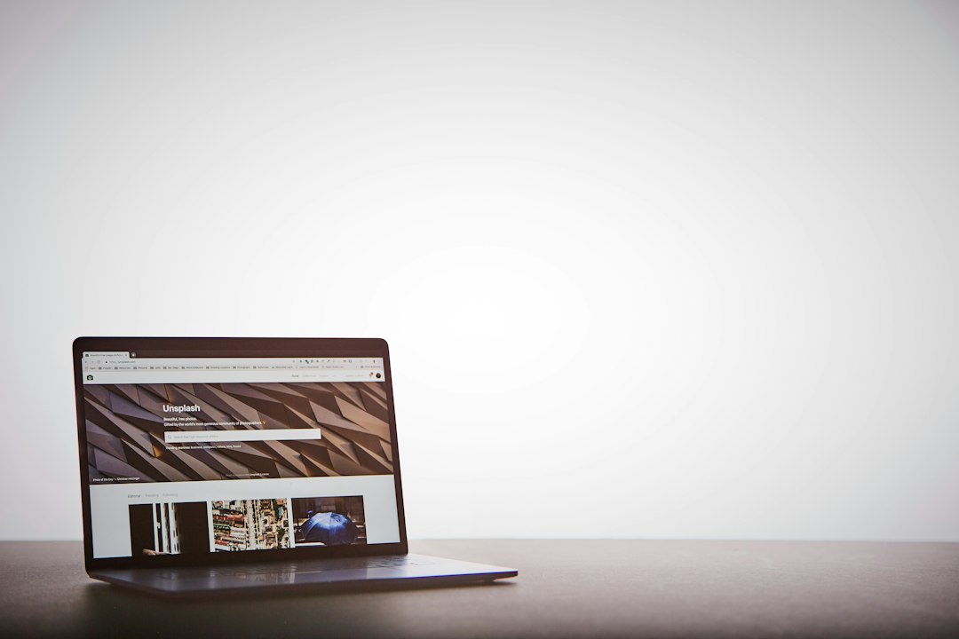 Business owner reviewing a website homepage on a laptop with notes highlighting headline clarity, call-to-action buttons, page speed, and trust signals